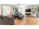 Cozy living room with stylish sofas, a flat-screen TV, and contemporary lighting at 10254 Martinsburg Ct, Las Vegas, NV 89183