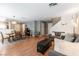 Open-concept living and dining area with wood flooring and comfortable seating at 10254 Martinsburg Ct, Las Vegas, NV 89183