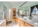 Bright bathroom features a double sink vanity, shower, and soaking tub offering a luxurious experience at 10310 Songsparrow Ct, Las Vegas, NV 89135