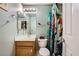 Cozy bathroom featuring a single sink vanity, mirrored medicine cabinet, and colorful shower curtain at 10310 Songsparrow Ct, Las Vegas, NV 89135