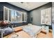 Bedroom features two windows, hardwood floors, and drumset with decor at 10310 Songsparrow Ct, Las Vegas, NV 89135