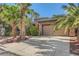 Charming single-story home featuring a well-kept lawn, desert landscaping, and an attached two-car garage at 10310 Songsparrow Ct, Las Vegas, NV 89135