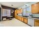 Bright kitchen features light wood cabinets, granite countertops, stainless steel dishwasher, and a breakfast nook at 10310 Songsparrow Ct, Las Vegas, NV 89135