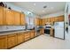 Functional kitchen with oak cabinets, stainless appliances, and ample counter space at 10310 Songsparrow Ct, Las Vegas, NV 89135