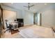 The bright main bedroom has hardwood floors, a ceiling fan and a dedicated desk area at 10310 Songsparrow Ct, Las Vegas, NV 89135