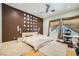 Spacious main bedroom with a unique accent wall, plush carpet, and a dedicated desk area for work or study at 10310 Songsparrow Ct, Las Vegas, NV 89135