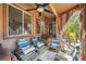 Relaxing covered patio area furnished with cozy seating, perfect for outdoor living at 10310 Songsparrow Ct, Las Vegas, NV 89135
