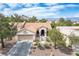 Aerial view of a lovely home with a tile roof and manicured desert landscaping at 10720 Sky Meadows Ave, Las Vegas, NV 89134