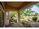 Private back patio area with picnic table and views of the lush landscaping at 10720 Sky Meadows Ave, Las Vegas, NV 89134
