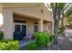 Charming covered back patio area with patio furniture and lush landscaping at 10720 Sky Meadows Ave, Las Vegas, NV 89134