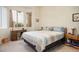 Bedroom featuring bright windows, a side desk, and a comfortable queen size bed at 10720 Sky Meadows Ave, Las Vegas, NV 89134
