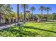 Beautifully landscaped community grounds featuring a large lawn, mature trees, and a decorative fountain at 10720 Sky Meadows Ave, Las Vegas, NV 89134