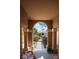 Covered entry way features beautiful archway leading to the street and a desert-landscaped front yard at 10720 Sky Meadows Ave, Las Vegas, NV 89134