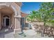 Welcoming front porch with seating area, arched entryway and desert landscaping at 10720 Sky Meadows Ave, Las Vegas, NV 89134