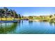 Picturesque golf course with a pond and mature trees and waterfall at 10720 Sky Meadows Ave, Las Vegas, NV 89134