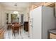 Bright eat-in kitchen with a view of the backyard features tile floors and modern appliances at 10720 Sky Meadows Ave, Las Vegas, NV 89134