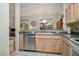 Well-maintained kitchen featuring a stainless steel dishwasher, neutral countertops, and a convenient layout for cooking at 10720 Sky Meadows Ave, Las Vegas, NV 89134