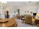 Bright and airy living room boasts large windows and an open floor plan with living and dining areas at 10720 Sky Meadows Ave, Las Vegas, NV 89134