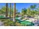 Miniature golf course with vibrant greenery, a flag, and a paved pathway at 10720 Sky Meadows Ave, Las Vegas, NV 89134