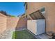 Backyard featuring artificial turf, gravel, pavers, and a storage unit at 10744 Yarmouth Bay Ct, Las Vegas, NV 89179