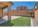 Backyard with artificial turf, pavers, desert landscaping, and covered patio at 10744 Yarmouth Bay Ct, Las Vegas, NV 89179