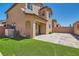 Backyard featuring artificial turf, hardscape, block wall, and covered patio at 10744 Yarmouth Bay Ct, Las Vegas, NV 89179