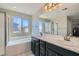 Bathroom featuring dual sinks, a soaking tub, and a glass-enclosed shower at 10744 Yarmouth Bay Ct, Las Vegas, NV 89179