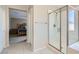 Bright bathroom featuring a modern shower with glass door and access to the bedroom at 10744 Yarmouth Bay Ct, Las Vegas, NV 89179