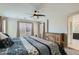 Comfortable bedroom with natural light, a ceiling fan, and a wooden dresser at 10744 Yarmouth Bay Ct, Las Vegas, NV 89179