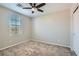 Cozy bedroom with a ceiling fan and natural light from a large window at 10744 Yarmouth Bay Ct, Las Vegas, NV 89179