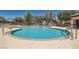 Community pool with ample seating, landscaping, and shade structure at 10744 Yarmouth Bay Ct, Las Vegas, NV 89179