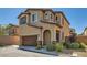 Charming two-story home featuring an attached two car garage and manicured landscaping at 10744 Yarmouth Bay Ct, Las Vegas, NV 89179