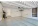 Spacious garage with epoxy flooring, storage racks, and shelving unit at 10744 Yarmouth Bay Ct, Las Vegas, NV 89179