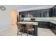 Bright kitchen featuring black cabinets, stainless appliances, granite counters, and a kitchen island with barstool seating at 10744 Yarmouth Bay Ct, Las Vegas, NV 89179