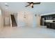 Spacious living area with stairs, an open floorplan, and modern tile that flows seamlessly into the kitchen at 10744 Yarmouth Bay Ct, Las Vegas, NV 89179