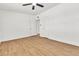 Bright bedroom with white walls, ceiling fan, and wood-look flooring at 1121 W Monroe Ave, Las Vegas, NV 89106
