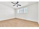 Bedroom featuring light-colored walls, a ceiling fan, and three windows at 1121 W Monroe Ave, Las Vegas, NV 89106