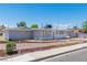 View of a light gray home with gated front yard and simple landscaping at 1121 W Monroe Ave, Las Vegas, NV 89106
