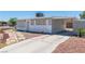 Charming single-story home with a gravel yard, carport, and a mix of stone and wood siding at 1121 W Monroe Ave, Las Vegas, NV 89106