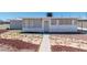 Charming single-story home with a stone-accented front yard and light gray exterior, and secure windows at 1121 W Monroe Ave, Las Vegas, NV 89106