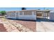 Charming single-story home with a carport and a rock and stone-accented front yard, and secure windows at 1121 W Monroe Ave, Las Vegas, NV 89106