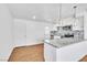 A beautifully renovated kitchen featuring white cabinets, stainless steel appliances, and granite countertops with modern hanging lights at 1121 W Monroe Ave, Las Vegas, NV 89106