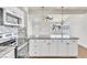 Bright kitchen featuring white cabinets, granite counters, stainless steel appliances, and a modern tile backsplash at 1121 W Monroe Ave, Las Vegas, NV 89106