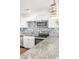Modern kitchen with white cabinets, granite countertops, stainless steel appliances, and stylish hanging lights at 1121 W Monroe Ave, Las Vegas, NV 89106