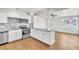 Stylish kitchen with white cabinets, granite countertops, stainless steel appliances, and a view into the sunny living area at 1121 W Monroe Ave, Las Vegas, NV 89106
