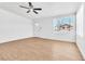 Spacious living room with wood-look floors, bright white walls, and natural light streaming through the window at 1121 W Monroe Ave, Las Vegas, NV 89106