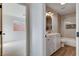 Bright bathroom featuring a vanity, tub, and neutral tile accents at 1506 Camino Summit Ave, Henderson, NV 89012
