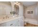 Well-lit bathroom with double sink vanity, tub, and modern fixtures at 1506 Camino Summit Ave, Henderson, NV 89012