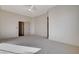 Spacious bedroom with neutral carpet, a ceiling fan, and a doorway to a walk-in closet at 1506 Camino Summit Ave, Henderson, NV 89012
