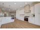 Modern kitchen design with white cabinets, stainless steel appliances, and an open layout to the living area at 1506 Camino Summit Ave, Henderson, NV 89012